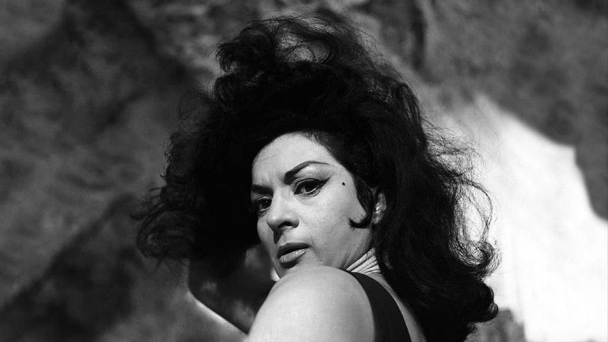 person holding mike up high on dim light