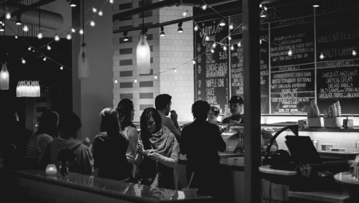 grayscale photography of people standing in line