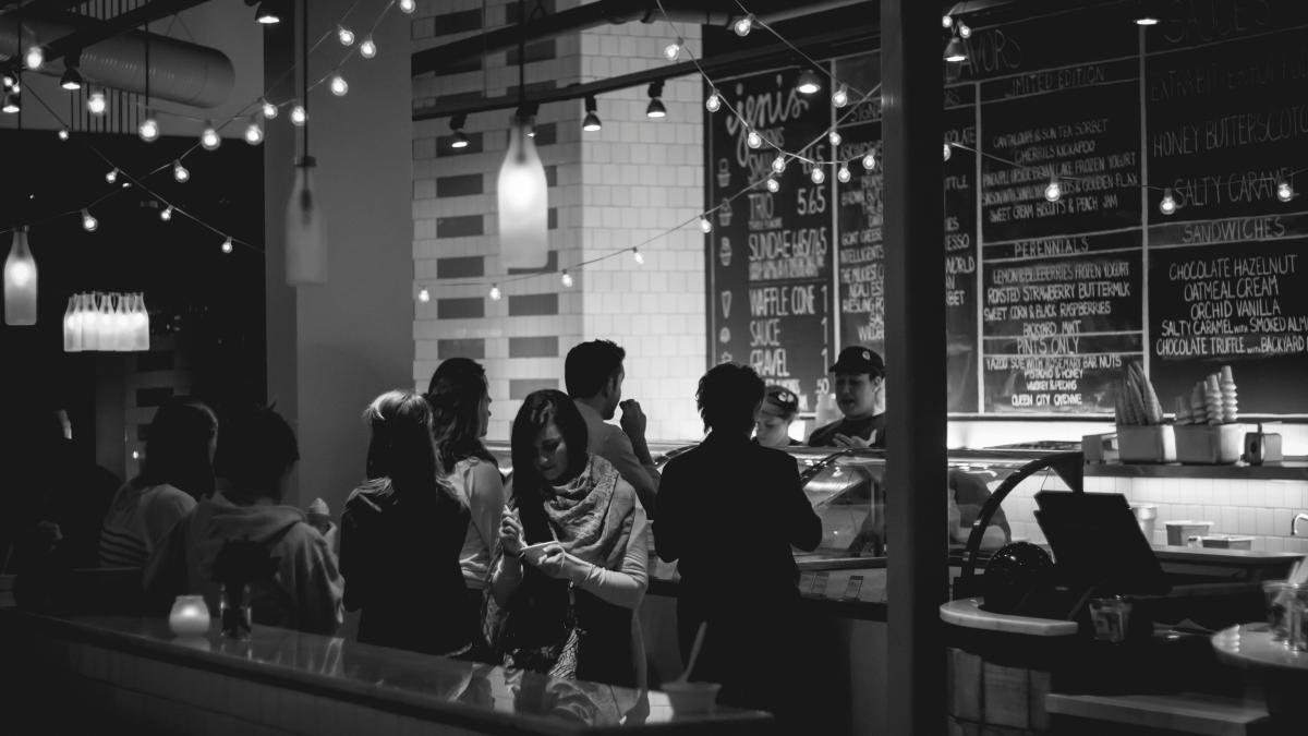 grayscale photography of people standing in line