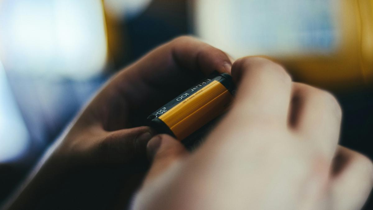 person holding brown and black battery
