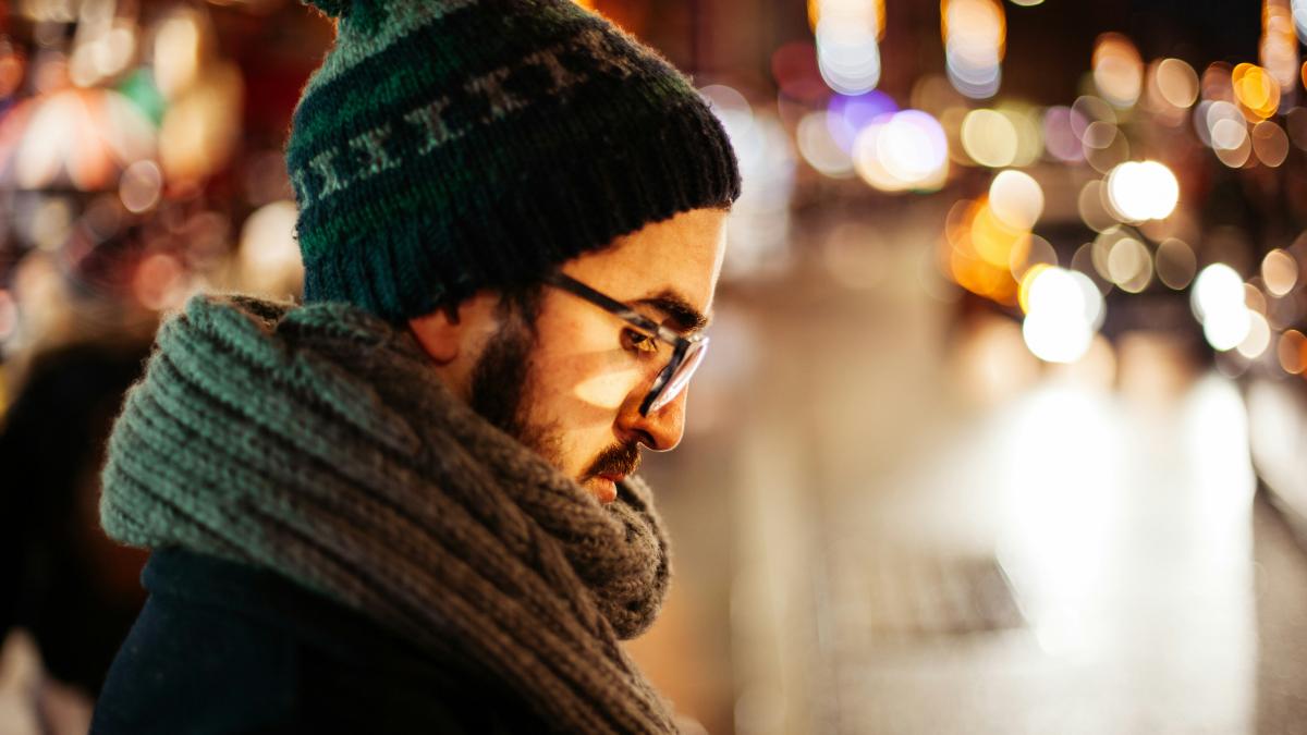 man looking down on side on the street