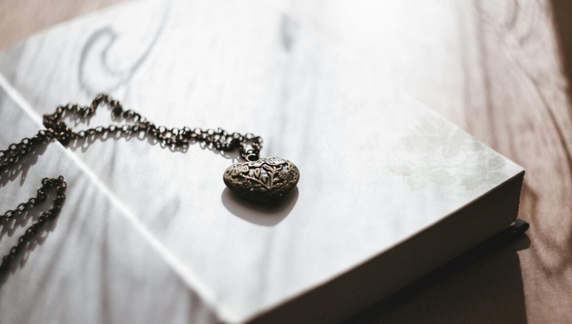 silver-colored necklace with pendant