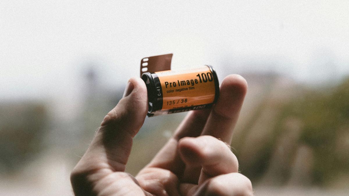 person holding Pro Image 100 tape