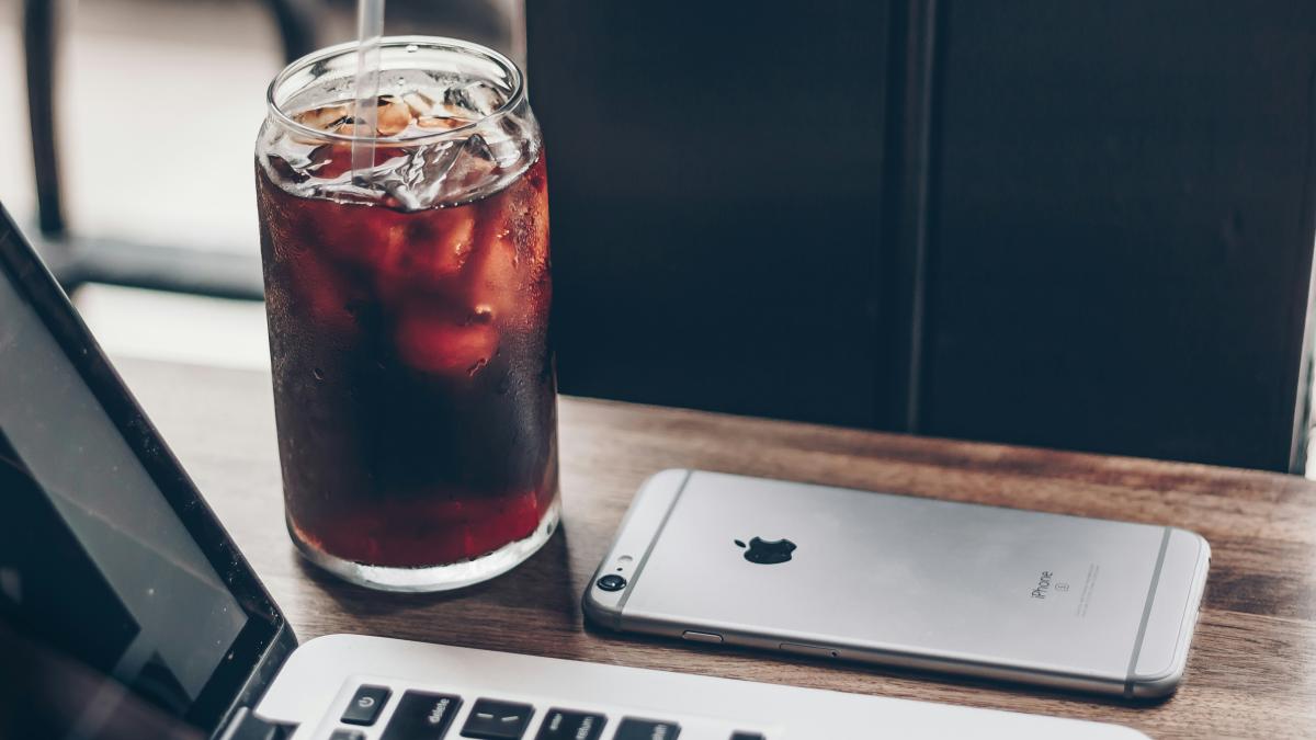 MacBook Pro beside space gray iPhone 6s