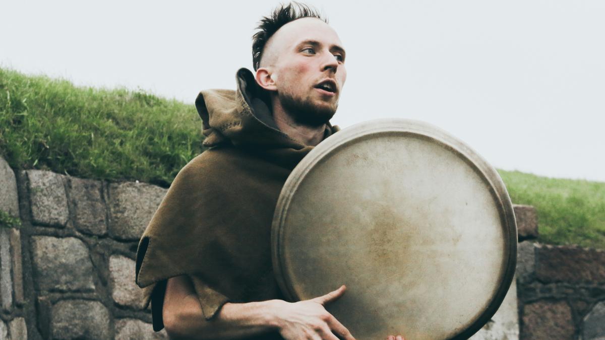 man holding round gray framed glass decor
