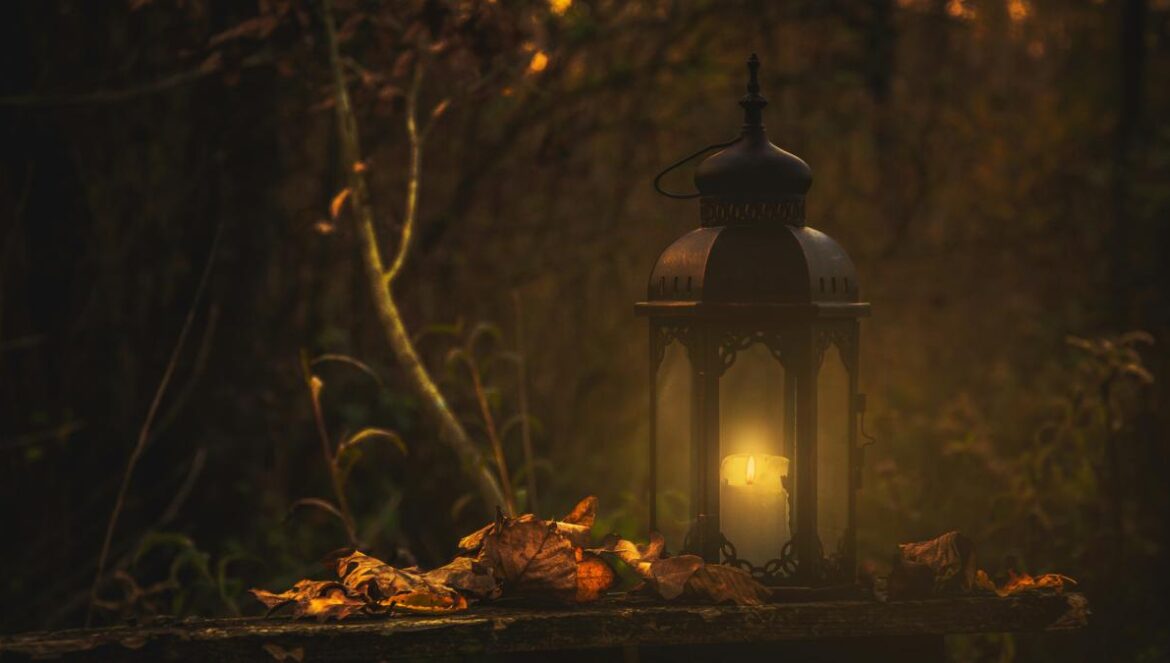 yellow pillar candle in black lantern