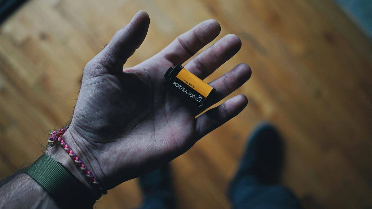 black camera film on person's hand