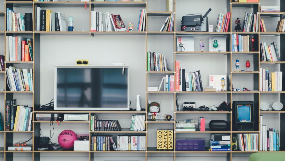 flat screen TV on brown wooden shelf