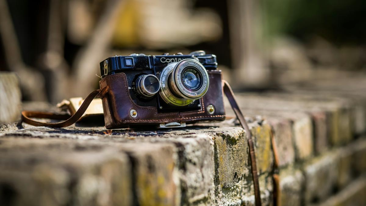 black SLR camera on brown brick surface