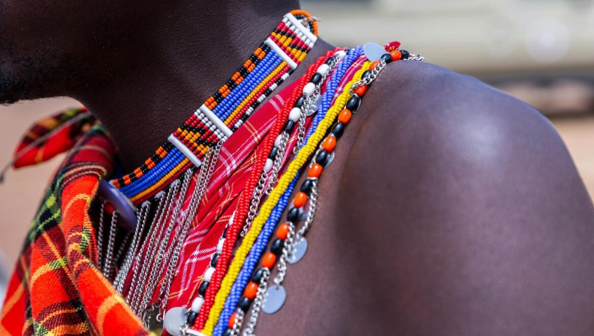 person wearing beaded multicolored necklace in selective focus photography