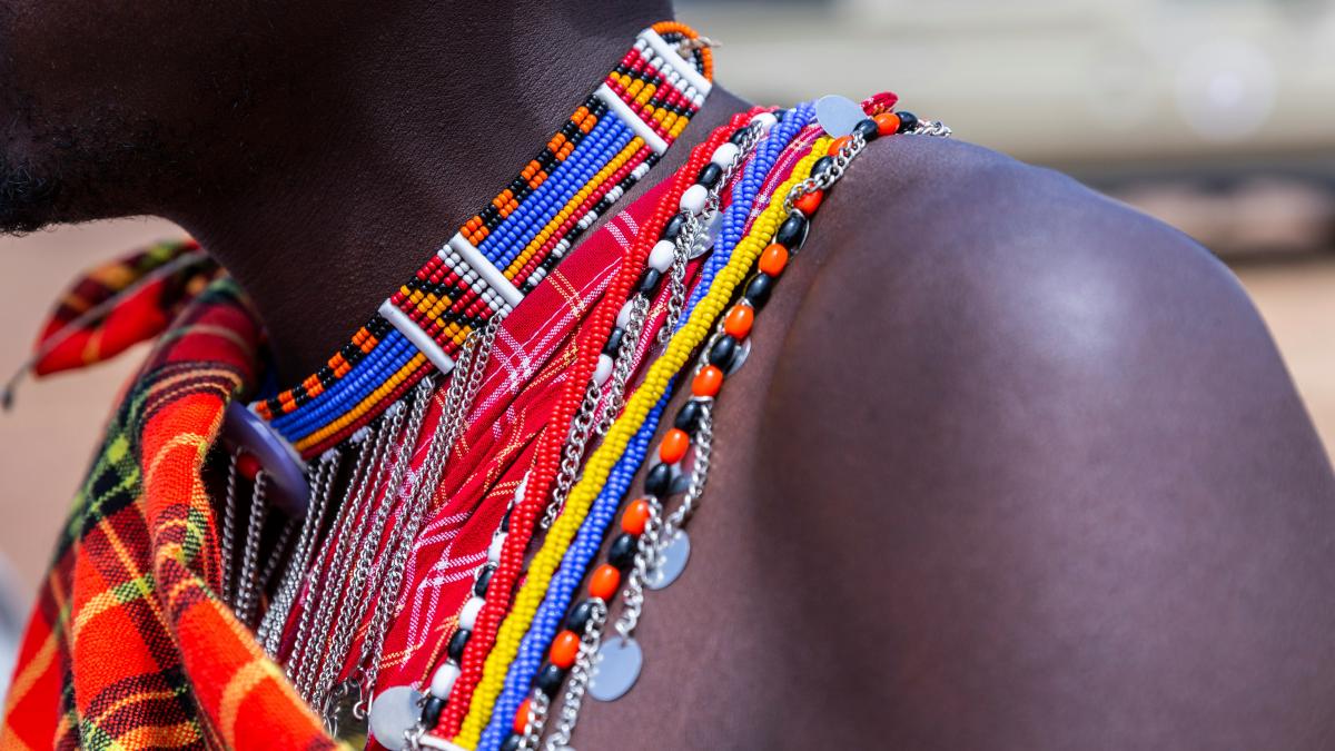 person wearing beaded multicolored necklace in selective focus photography