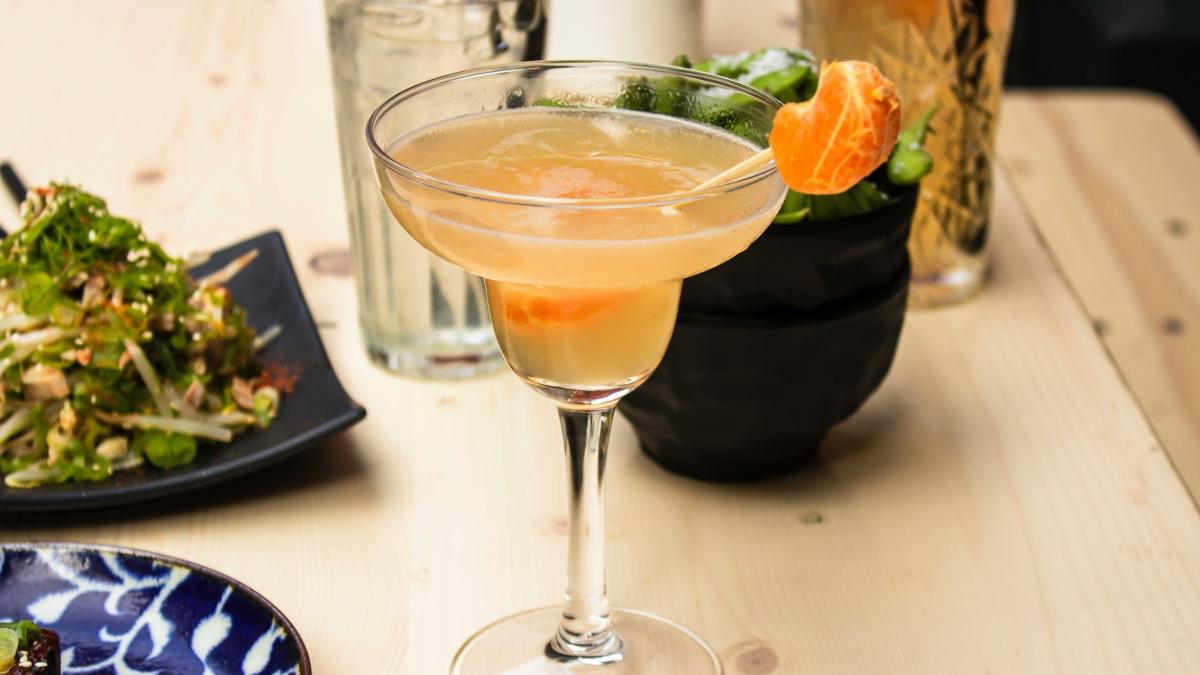 beverage filled clear cocktail glass on wooden surface