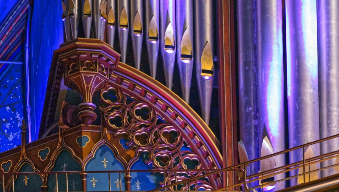a pipe organ in a church with blue lighting