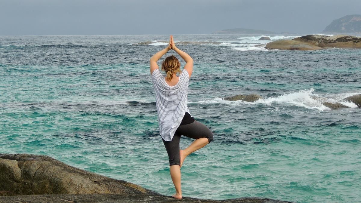 woman wearing white blouse standing on the seashore