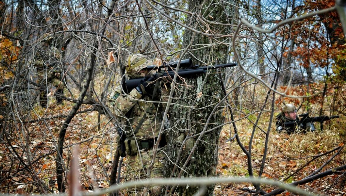 man aiming rifle