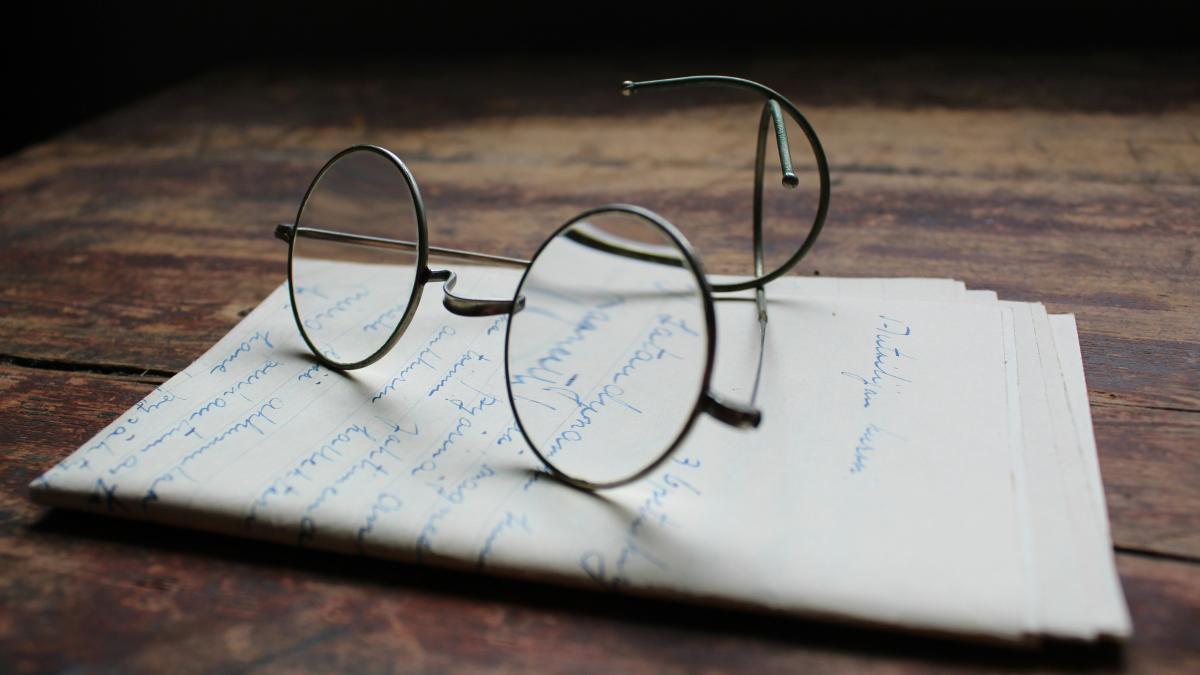 silver framed eyeglasses on white printer paper