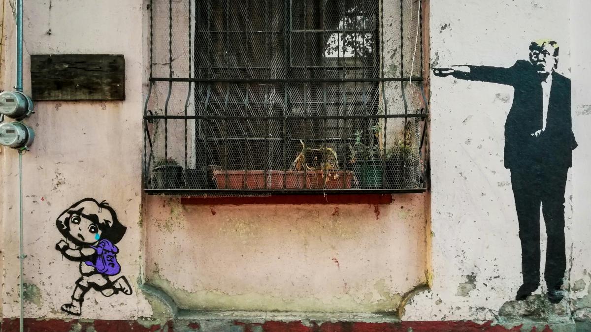 black metal window grill on white concrete wall