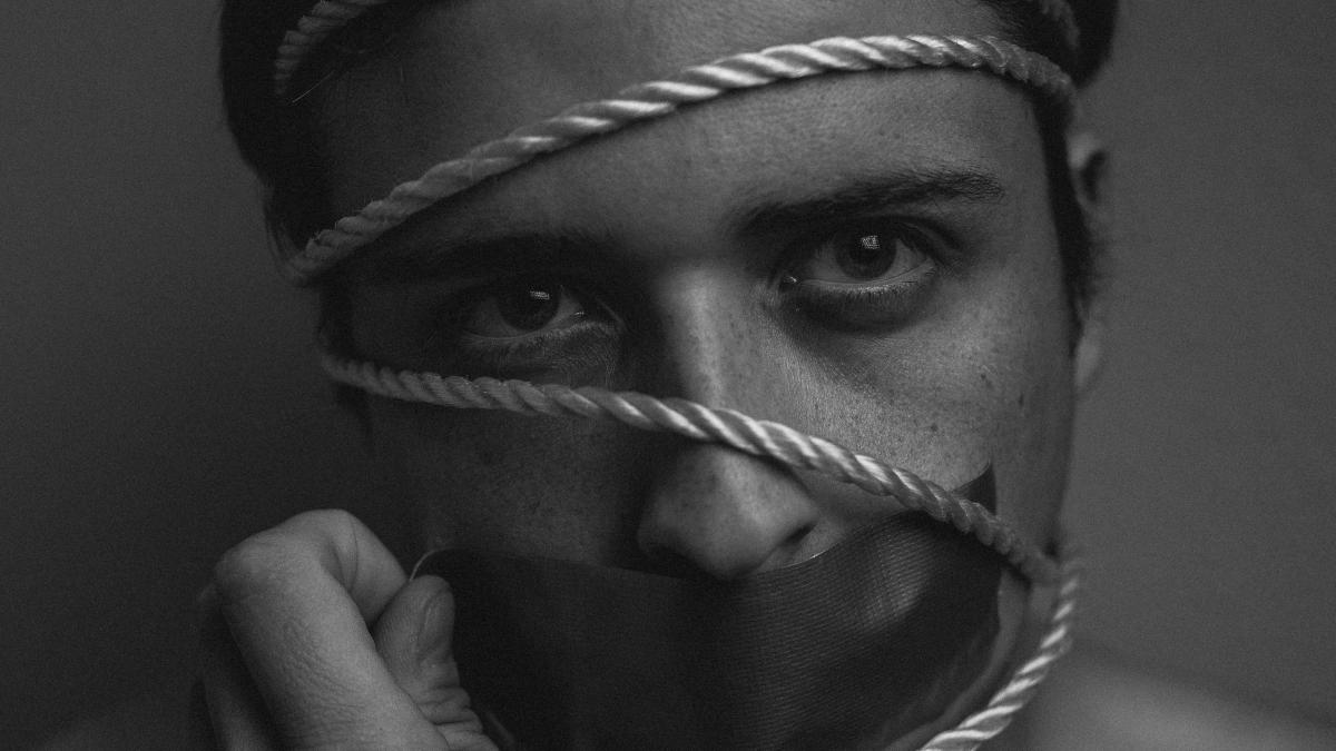 grayscale photo of person holding rope