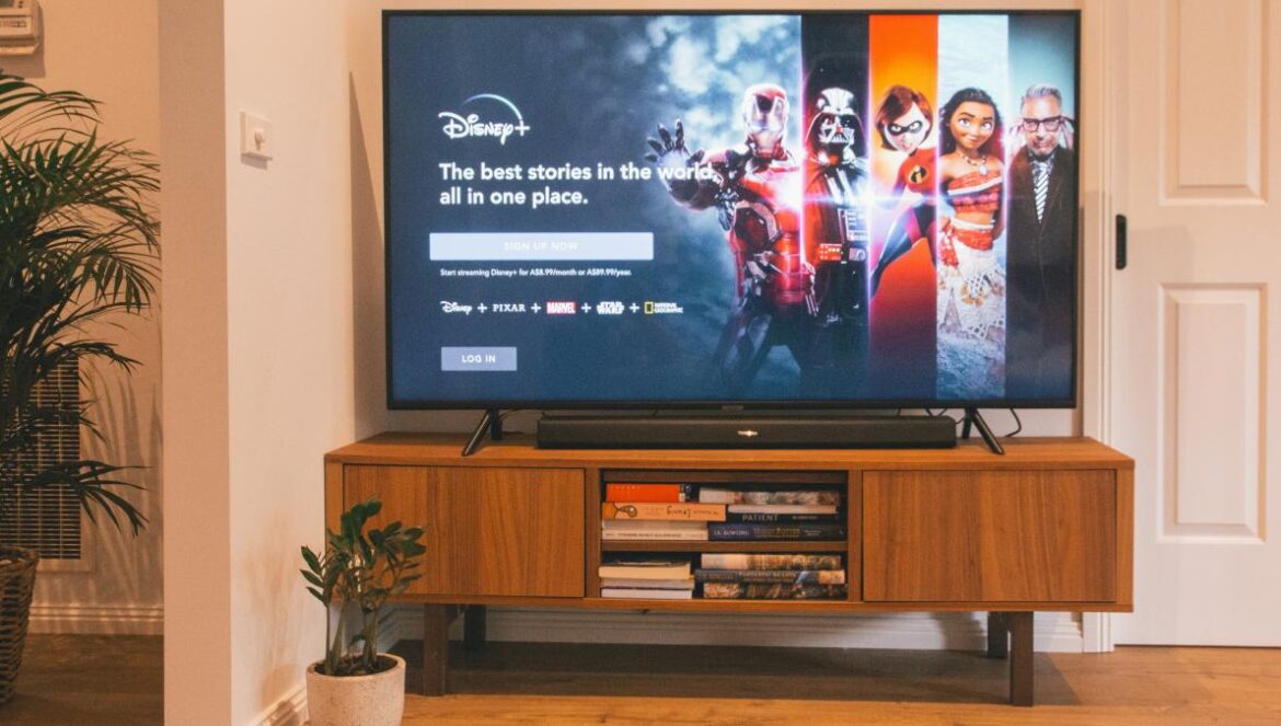 black flat screen tv turned on on brown wooden tv rack