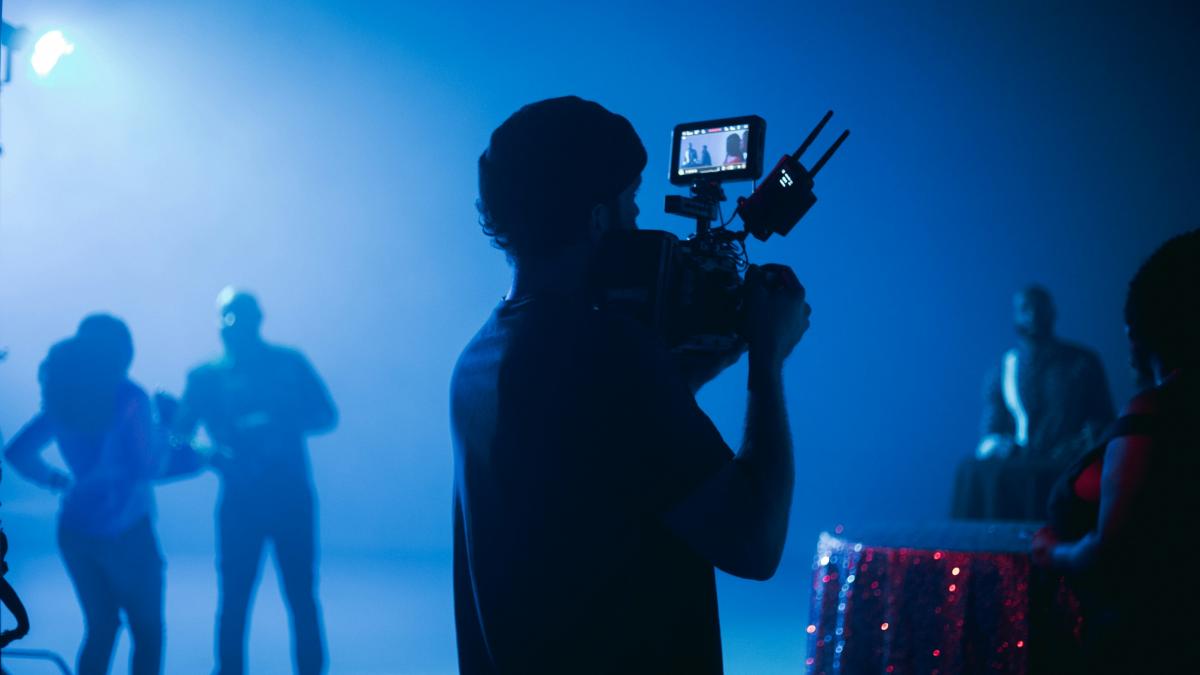 silhouette of man holding camera