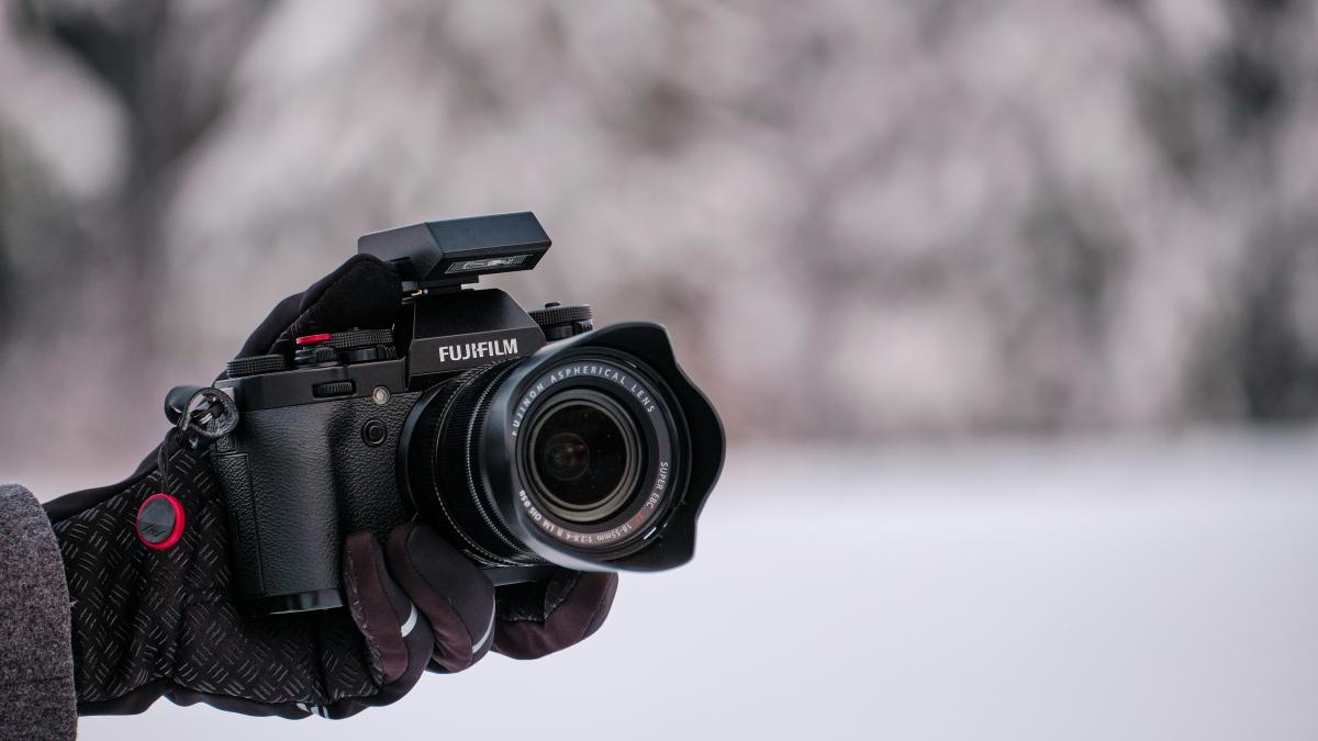 person holding black nikon dslr camera