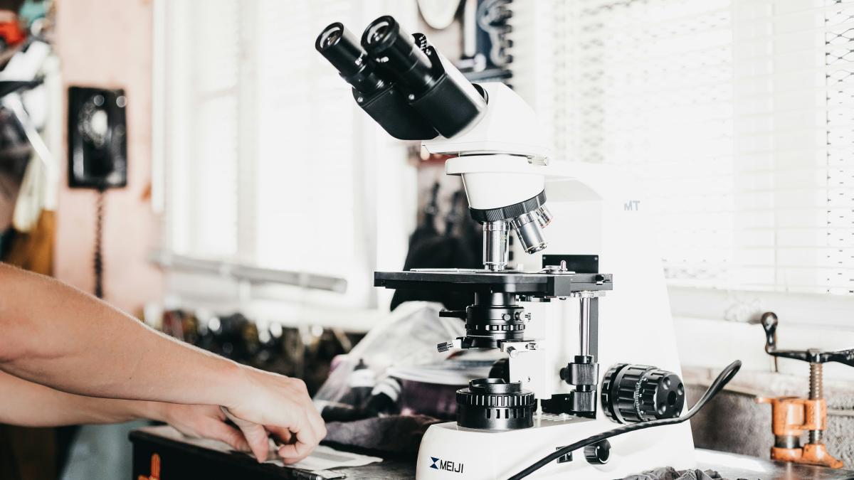 person holding black and white espresso machine