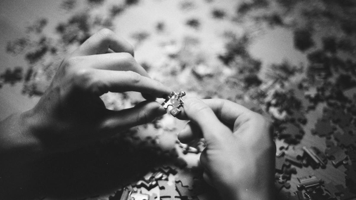 grayscale photo of person holding flower