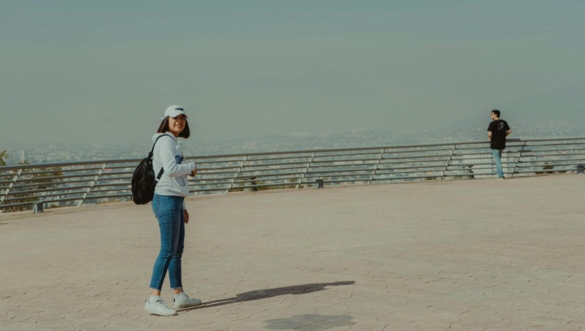 man and woman standing on sand during daytime