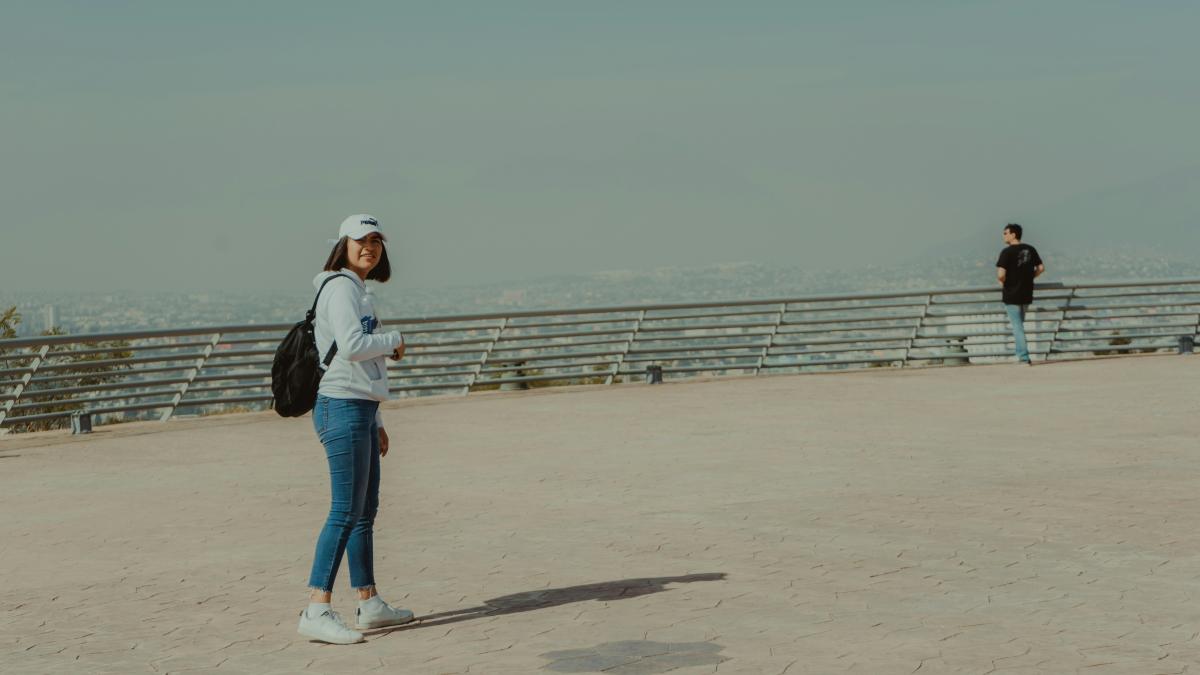 man and woman standing on sand during daytime
