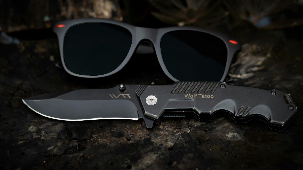 black framed sunglasses on black and gray surface