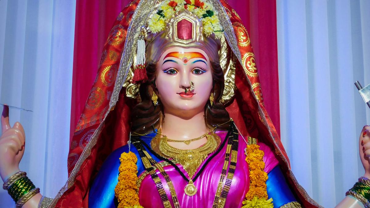 woman in red and gold sari