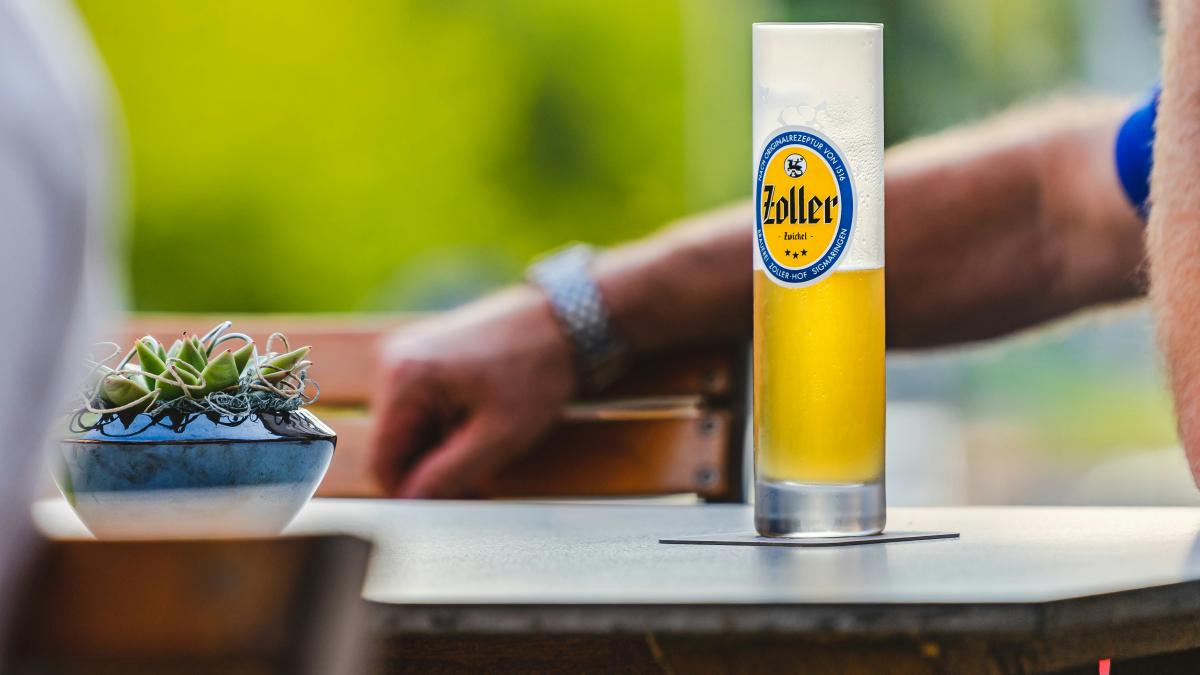 person holding white ceramic bowl with yellow liquid