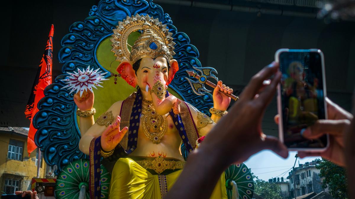 woman in yellow dress holding gold trophy