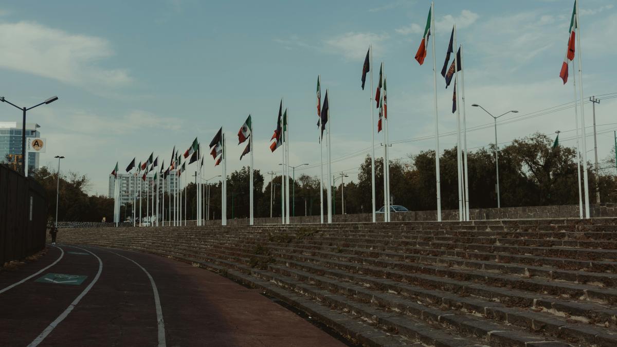 a bunch of flags that are next to some steps