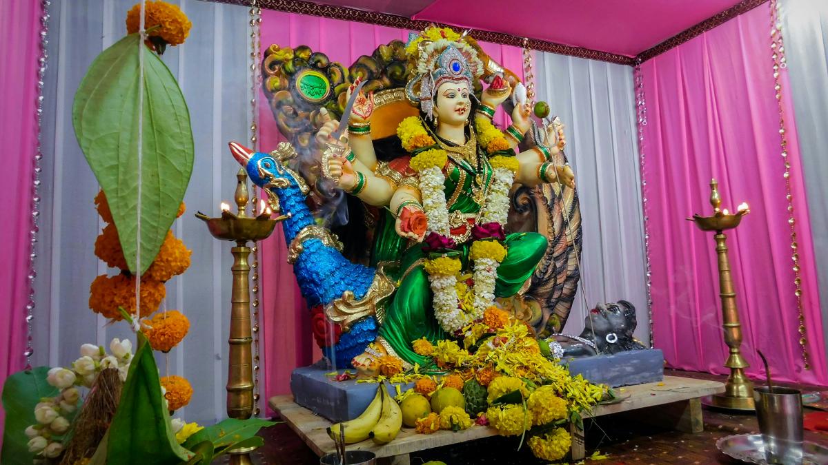 a statue of a woman sitting on top of a table