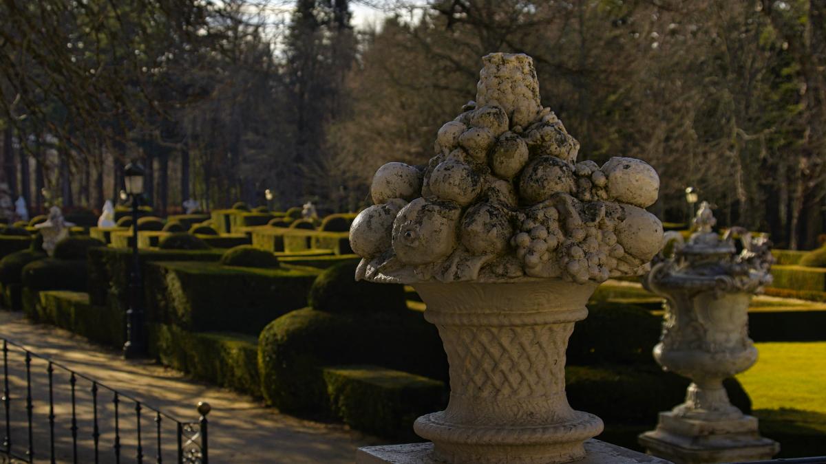 a large vase filled with lots of fruit on top of a table