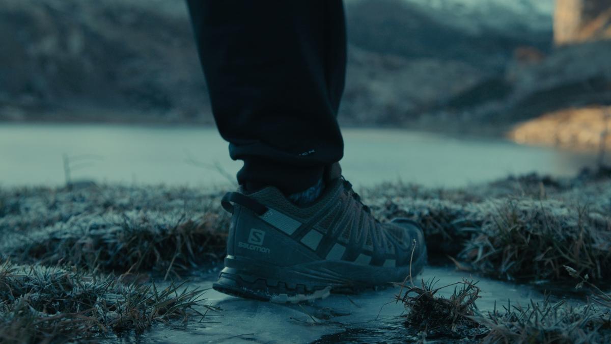 a person standing in the snow with their feet on the ground
