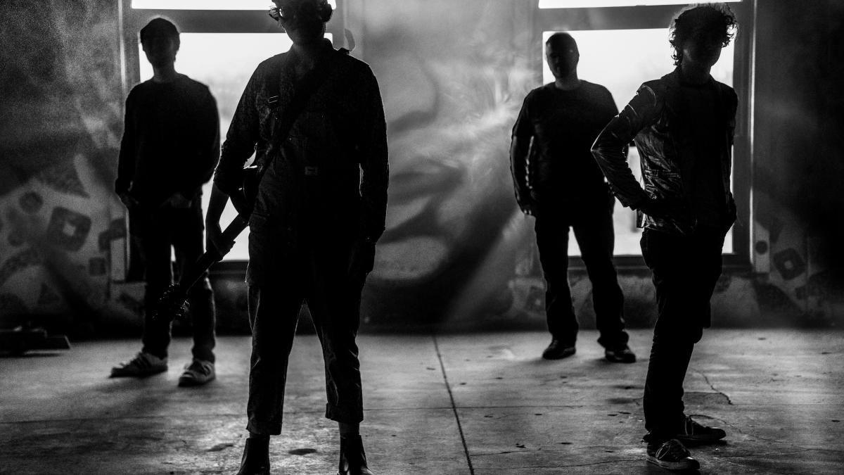 a group of young men standing in front of a window