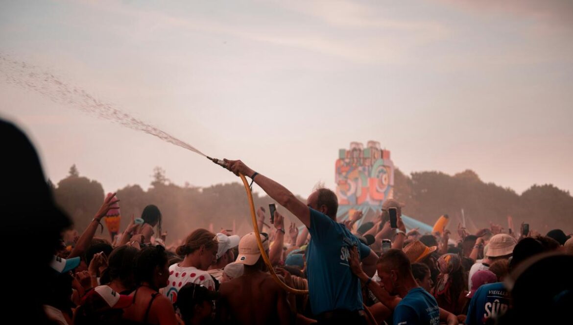 a man holding a stick in front of a crowd of people