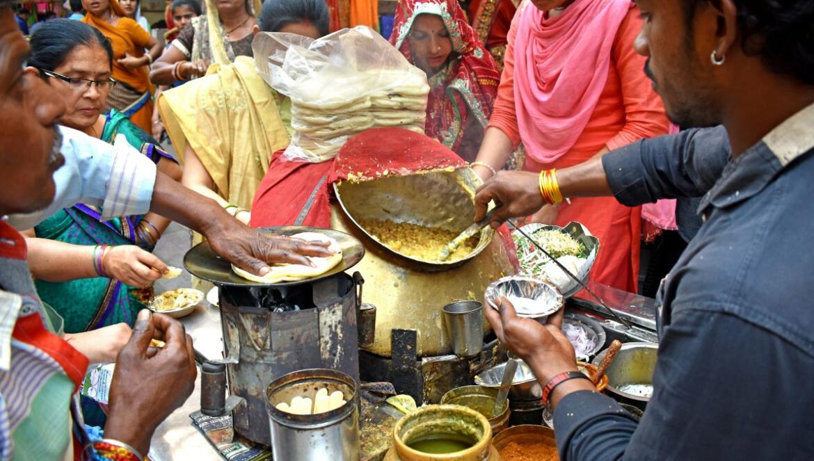 a group of people cooking in a kitchen