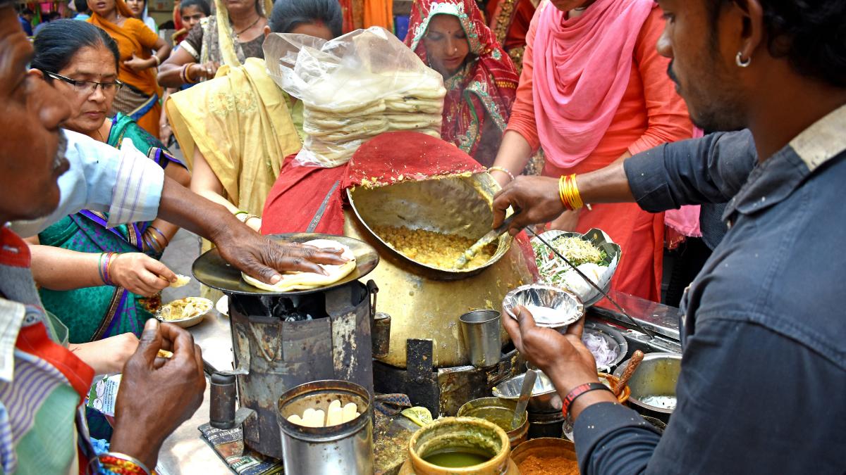 a group of people cooking in a kitchen
