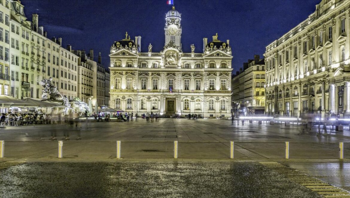 a large building with a fountain in front of it