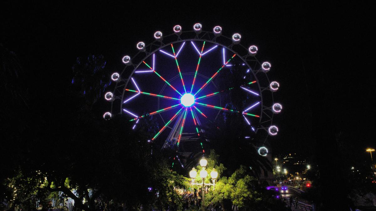 a large ferris wheel lit up at night