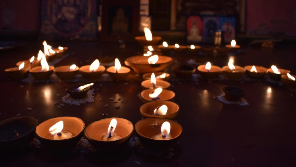a group of lit candles sitting on top of a table