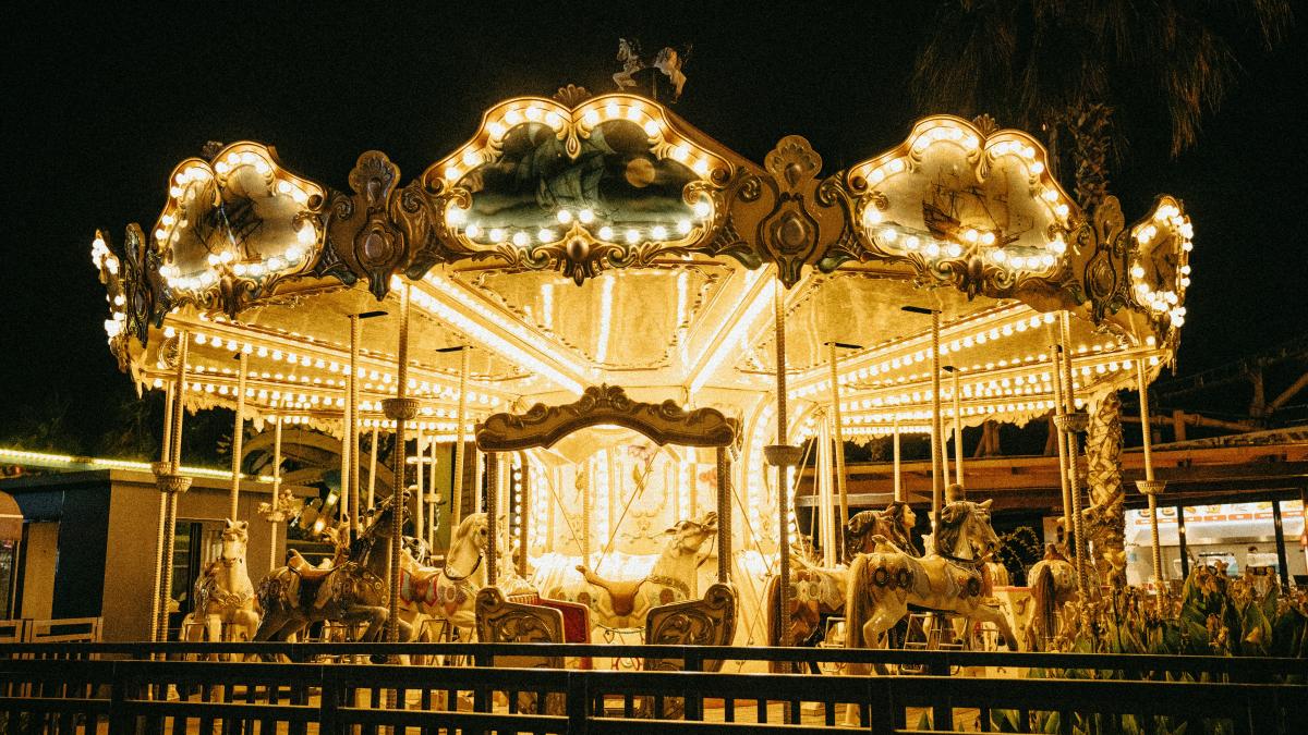 a merry go round at night with lights on