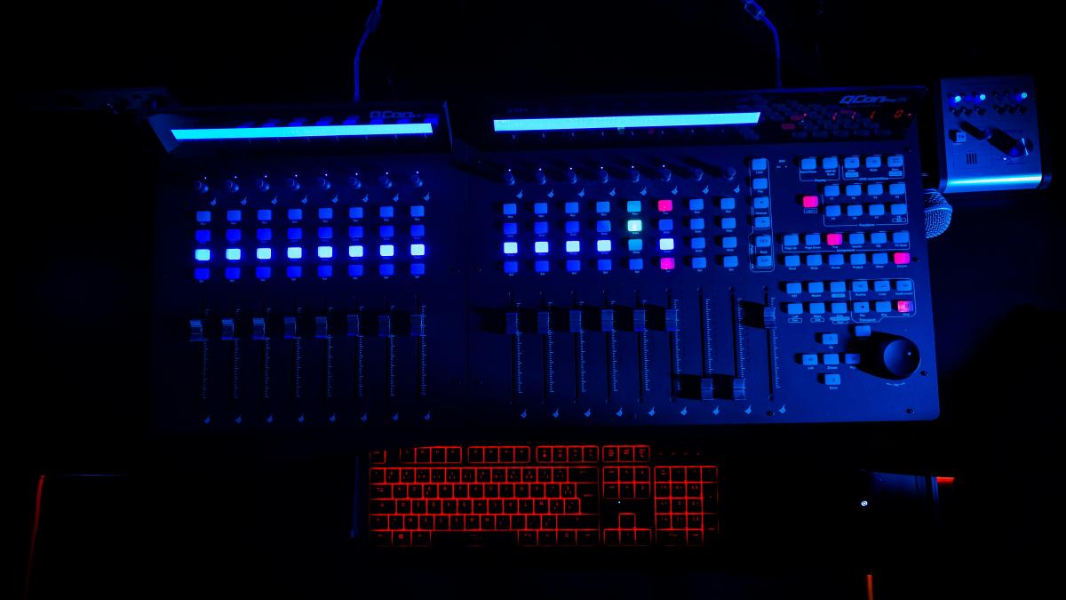 a computer with a lot of buttons on it in the dark