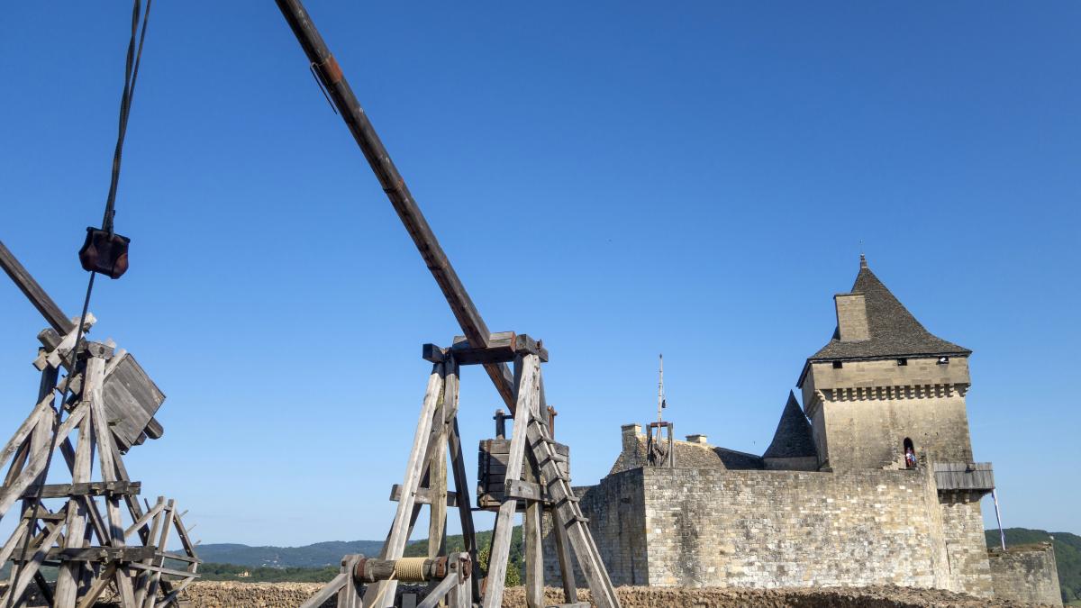 a couple of wooden structures sitting in front of a castle