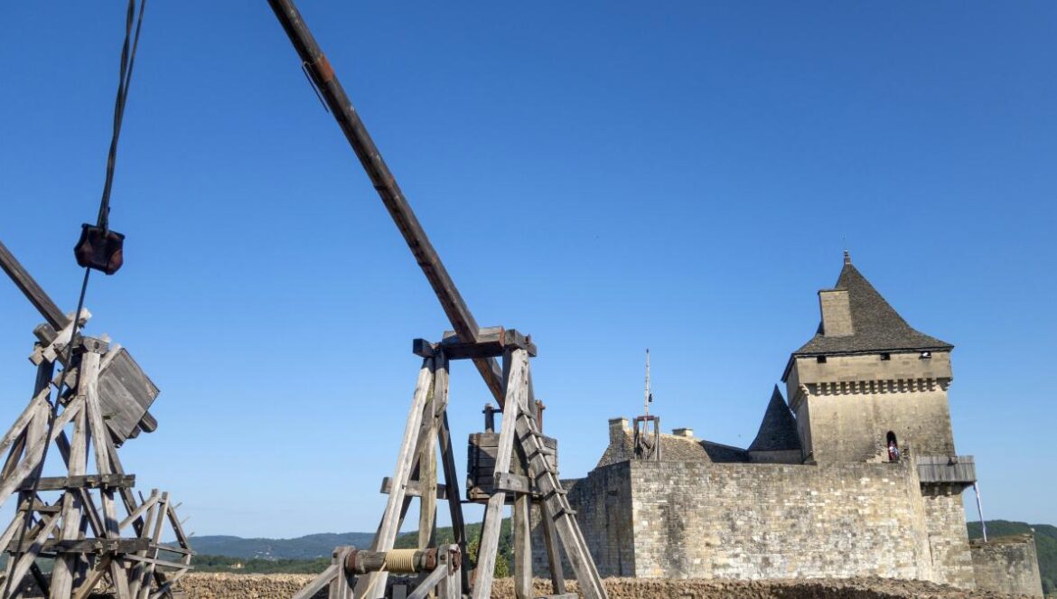 a couple of wooden structures sitting in front of a castle