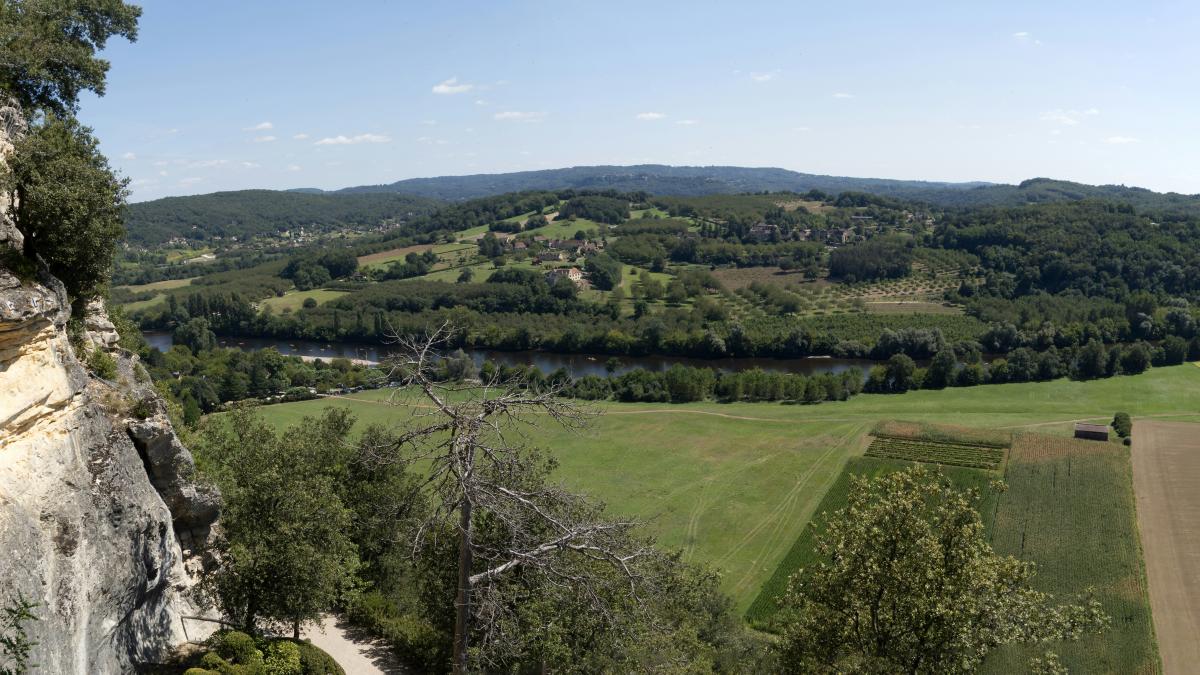 a view of a valley and a river from a cliff