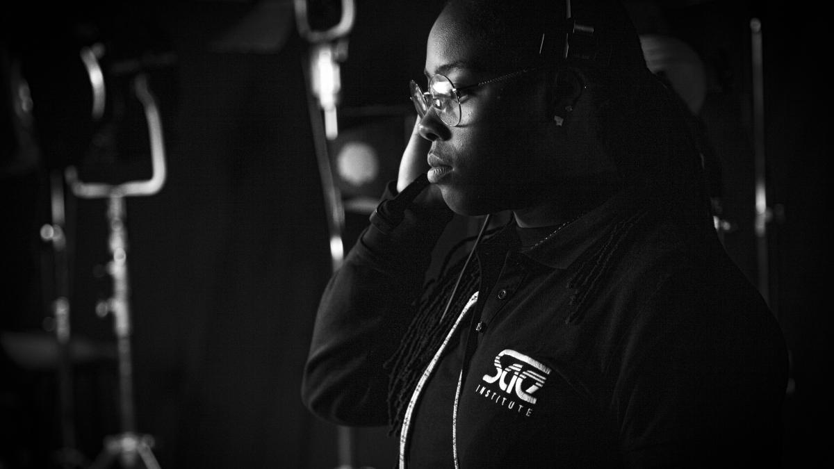 a man in a recording studio talking on a cell phone